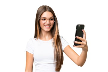Teenager caucasian girl over isolated background making a selfie