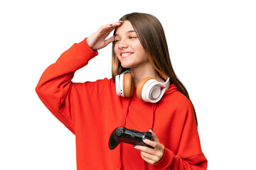 Obraz premium Teenager caucasian girl playing with a video game controller over isolated background smiling a lot