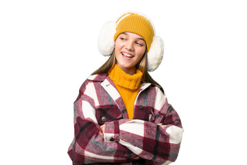 Teenager caucasian girl wearing winter muffs over isolated background happy and smiling