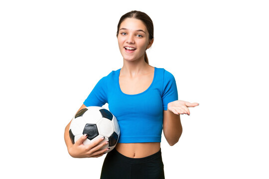 Teenager caucasian girl playing football over isolated background with shocked facial expression