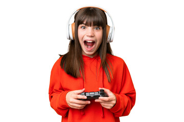 Little caucasian girl playing with a video game controller over isolated background with surprise...