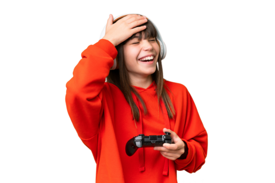 Little caucasian girl playing with a video game controller over isolated background smiling a lot