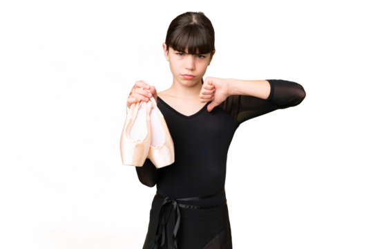 Little caucasian girl practicing ballet over isolated background showing thumb down with negative expression