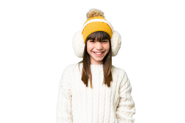 Little caucasian girl wearing winter muffs over isolated background with surprise facial expression