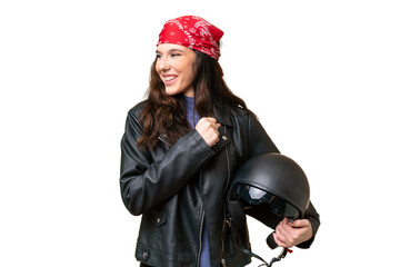 Young caucasian woman with a motorcycle helmet over isolated background celebrating a victory