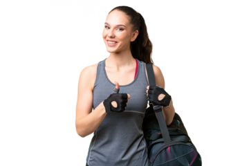 Young sport woman with sport bag over isolated background giving a thumbs up gesture