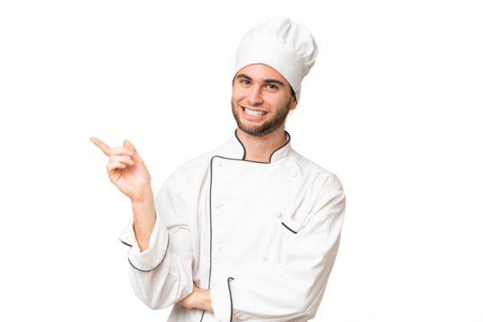 Young handsome chef man over isolated background pointing finger to the side