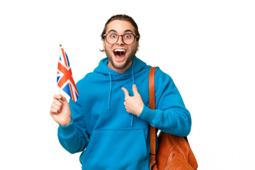 Young handsome man holding an United Kingdom flag over isolated background with surprise facial expression