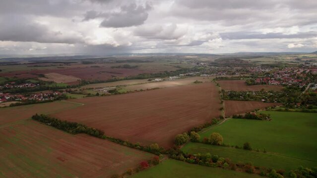 Aer ial view of a German village surrounded by meadows, farmland and forest in Germany.
