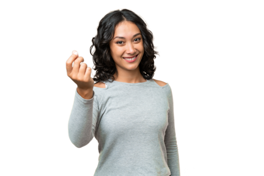Young Argentinian woman over isolated background making money gesture