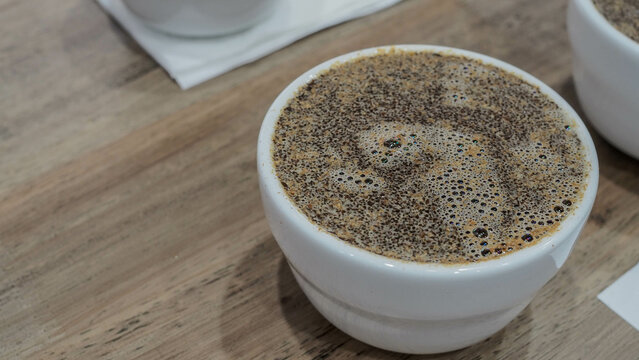 coffee cupping, pour 150 grams of hot water into cup.
Scent to the aromas of the wet coffee.  take note of what you smell.