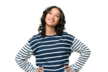 Young Argentinian woman over isolated background posing with arms at hip and smiling