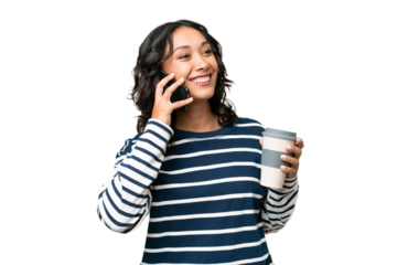 Young Argentinian woman over isolated background holding coffee to take away and a mobile