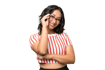 Young Argentinian woman over isolated background with glasses and happy