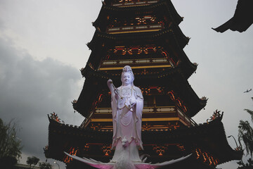 A Pagoda in the center of a Chinatown with the statue of Guan Yin.
