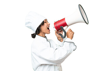 Young chef Argentinian woman over isolated background shouting through a megaphone