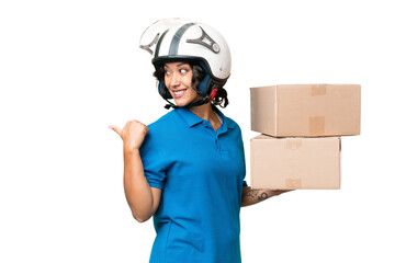 Young Argentinian  delivery woman over isolated background pointing to the side to present a product