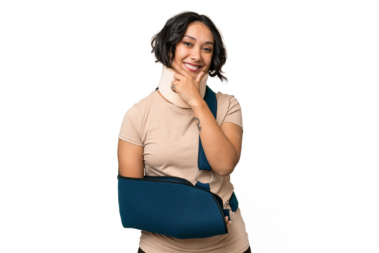 Young argentinian woman wearing neck brace and sling over isolated background happy and smiling