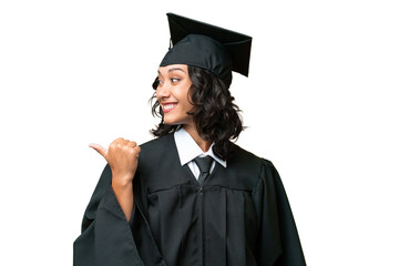 Young university graduate Argentinian woman over isolated background pointing to the side to...