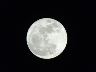 Genova, Italy-July 14, 2022: Beautifull full moon. Summer super moon with dark background behind. Moon detail in summer days.