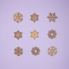 Pattern made of snowflakes on bright pastel purple background. Creative winter season idea. Minimal New Year or Christmas concept. Winter with snow idea.