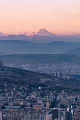 top view of tbilisi at dusk and the top of Mount Kazbek on the horizon