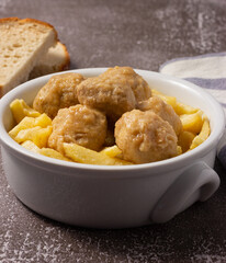 Delicious homemade meatballs with potatoes and traditional sauce.