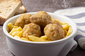 Delicious homemade meatballs with potatoes and traditional sauce.