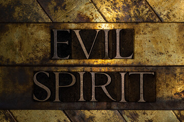 Evil Spirit text with on grunge textured copper and gold background 