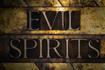 Evil Spirit text with on grunge textured copper and gold background 
