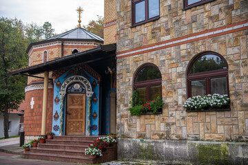 Fototapeta na wymiar Orthodox Monastery of St.Archangel (Tresije) on mountain Kosmaj, Exterior with frescoes. Sopot, Serbia 10.09.2022