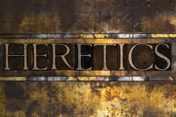 Heretics text with on grunge textured copper and gold background 
