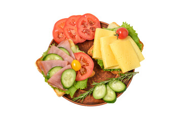 Homemade sandwich with ham, cheese, tomato and cucumber on wooden plate
