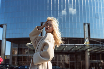 Fototapeta premium Young blonde woman in autumn city