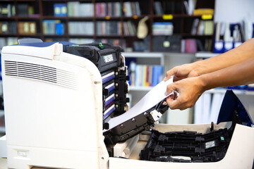 Technician hand open cover photocopier or photocopy to fix repair copier paper jam and replace ink...