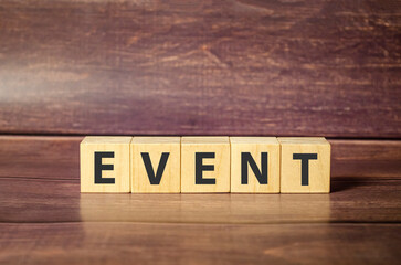 Event word on wooden blocks and brown background