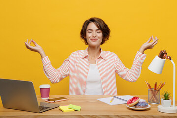 Young employee business woman wear shirt sit work at office desk with pc laptop hold spread hands...
