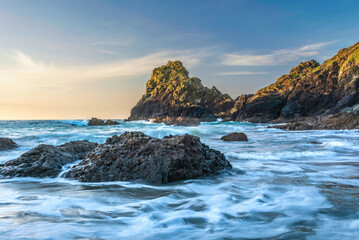 Beautiful dawn landscape over Kynance Cove in Cornwall England with vibrant sky and beautiful turquoise ocean