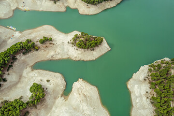Naklejka premium The drone aerial view of Guadalhorce reservoir in the mountains of Andalusia in southern Spain in summer. 