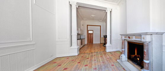 Empty apartment with two classical fireplaces and designed hardwood floor