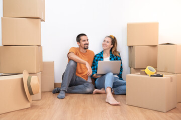 Attractive young couple with moving boxes becoming independent and opening a new home household move