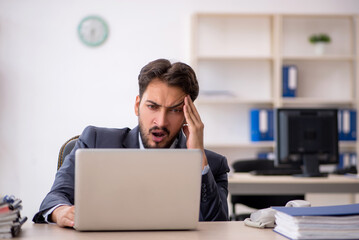 Young male employee working in the office