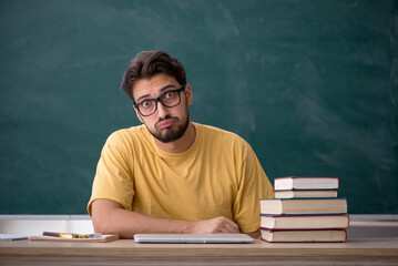 Young male student preparing for exams in the classroom