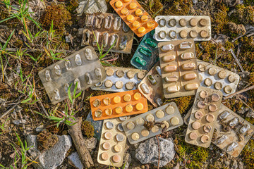 Different medicines: tablets discarded in nature