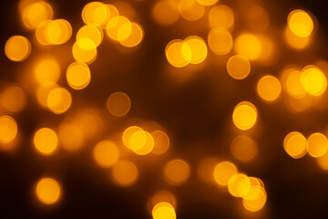 Abstract background, orange bokeh on a black background.