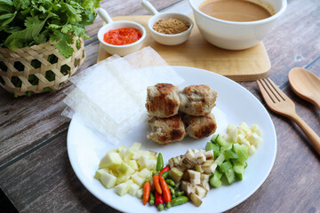 Nem Nuong - Vietnamese food of grilled pork sausage eat with rice paper and vegetables 
