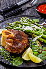 braised osso buco with grilled asparagus, top view