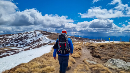 Rear view of man with backpack on hiking trail from Ladinger Spitz to Gertrusk, Saualpe, Lavanttal...