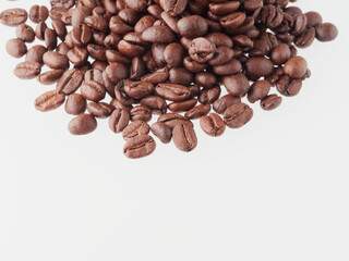 roasted coffee beans macro on a white background with free space