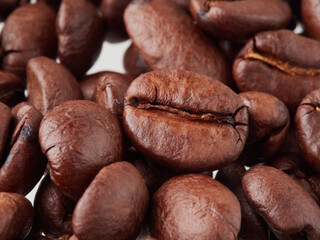 roasted coffee beans macro on a white background with free space